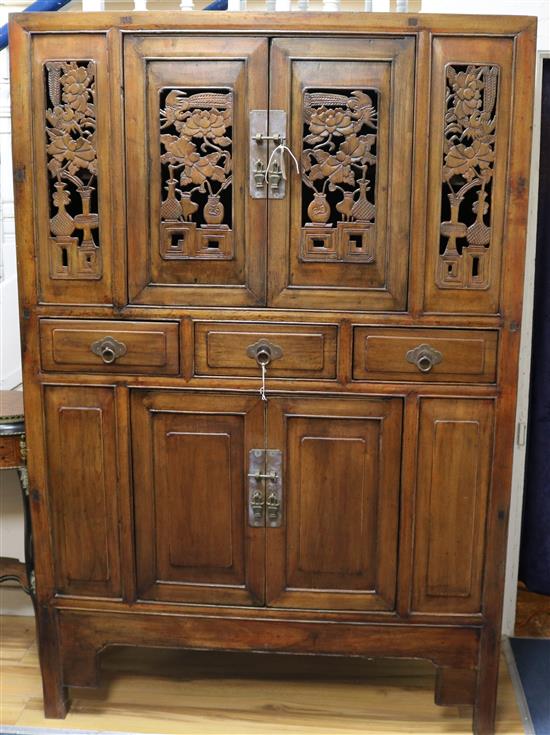 A Chinese carved and pierced wood cabinet W.120cm